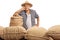 Disappointed elderly farmer posing with burlap sacks