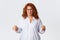 Disappointed and frustrated middle-aged redhead woman in glasses complaining bad service, looking skeptical and unamused