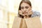 Disappointed girl sitting with shopping bags outdors