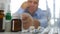 Disappointed Man Checking Medical Pills Stock On Pharmacy Shelf