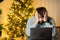 A disappointed man sits in front of a computer on New Year`s Eve in the office