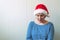Disappointed woman with Christmas Santa Claus hat suffering from