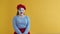 Disappointment and crying shows a woman in a cosplay mime, on an orange background. Upset mime crying and screaming