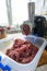 Disassembled automatic meat grinder. The preparation of the filling for dumplings