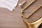 Disassembled golden trombone and scores on wooden table detail