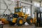 A disassembled Komatsu loader stands in the repair shop.