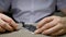 Disassembled phone in a repair shop. An electronics repairman to unscrew the bolts from the smartphone case