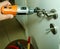 Disassembling a faulty door handle with an electric screwdriver