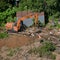 Disassembly of buildings in the forest by construction machines - Moscow, Russia, June 26, 2020