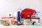 Disaster supply kit for earthquake on white wooden table near brick wall