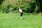 Disc golf player throwing a flying disc in the park