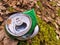 Discarded green aluminium beer or soda can in a forest