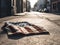 Discarded miniature American flag lies on concrete, covered in dust and dirt