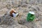 Discarded Paper coffee cup on ground. Disposable coffee cup on sand. The problem of environmental pollution. Pile of abandoned