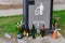 Discarded wine and beer bottles in front of a recycling deposit bin