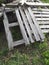 Discarded wooden pallets abandoned. Stack of wooden boards background. Pile of grunge wood pallets placed randomly, dumped in