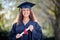 Discipline is the bridge between goals and accomplishment. Portrait of a young woman holding her diploma on graduation