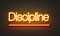 Discipline neon sign on brick wall background.