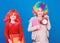 Discipline and time concept. Circus school education. Time to have fun. Kids colorful curly wig clown style hold alarm