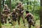 A disciplined and specialized military unit, donned in camouflage, strategically patrolling and maintaining control in a