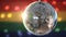 Disco ball revolving against gay pride flag