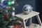 Disco ball on a stool near  Christmas tree as an interior decoration