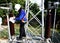 Disconnecting switch insulator cleaning by a worker at Take-off tower in substation