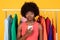 Discontented Black Female Buyer With Smartphone Posing On Yellow Background