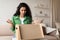 Discontented Female Customer Unpacking Cardboard Box At Home