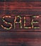 Discounts and sales, lettering on a wooden background. Advertising picture for seasonal discounts, creative concept for stores.