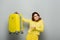 discouraged woman pointing at yellow suitcase