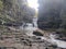 Discover the Enchanting Waterfall Retreat amidst Rocky Splendor