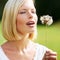 Discovering the whimsical side of nature. Cute young woman preparing to blow at a dandelion.