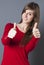 Discreet beautiful young woman smiling with thumbs up