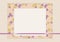 A discreet vector beige greeting card scrapbooking composition of sheets of paper with a thin purple shiny ribbon and a pattern in