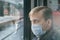 Disease outbreak, coronavirus covid-19 pandemic, virus protection. Portrait of frightened adult man with medical protective mask