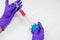Diseased and recovery concept, a hand with purple glove is holding a simulated virus and another hand injected red liquid