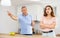 Disgruntled father scolds his adult daughter in the kitchen