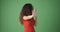 Disgust woman giving stop gesture over green background