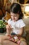 Disgusted girl playing observing toy bugs with a magnifying glass