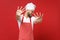 Disgusted scared young male chef cook or baker man in striped apron white t-shirt toque chefs hat posing isolated on red