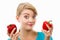 Disgusted woman holding in hand old wrinkled and fresh peppers, white background