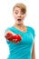 Disgusted woman holding in hand old wrinkled and fresh peppers, white background