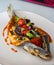 Dish of baked bream with vegetables in a gourmet restaurant