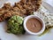 dish with beef milanesa, chilaquiles in green sauce, guacamole and beans