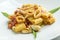 Dish of calamarata pasta with squid and tomato