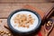 Dish of cereal with milk and wooden spoon