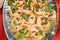 dish of delicious tartlets with seafood in cream sauce and parsley close up