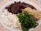 Dish with feijoada with farofa and cabbage