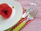 Dish fork knife serving towel on a wooden background red poppy